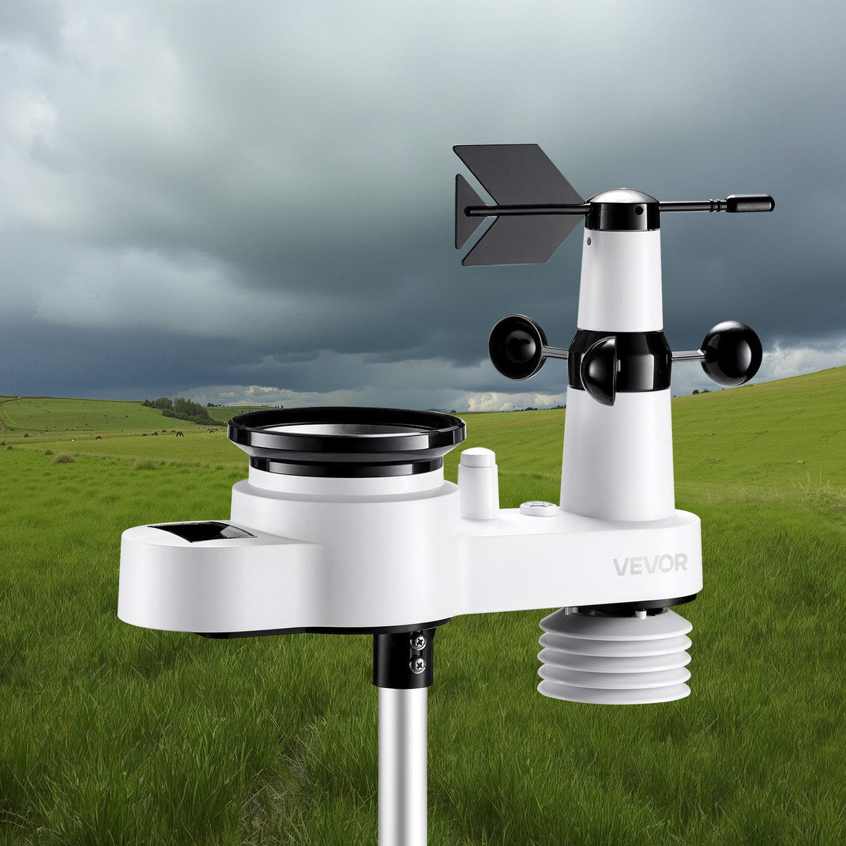 Weather station with anemometer on a grassy field with a cloudy sky