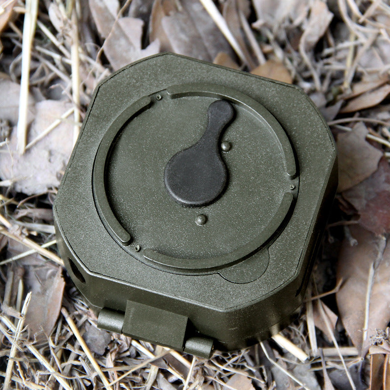 Green hunting blind box on dry grass