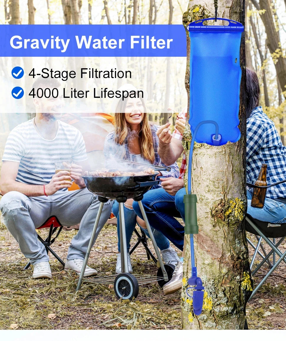 Blue gravity water filter hanging from a tree with people around a campfire in the background.
