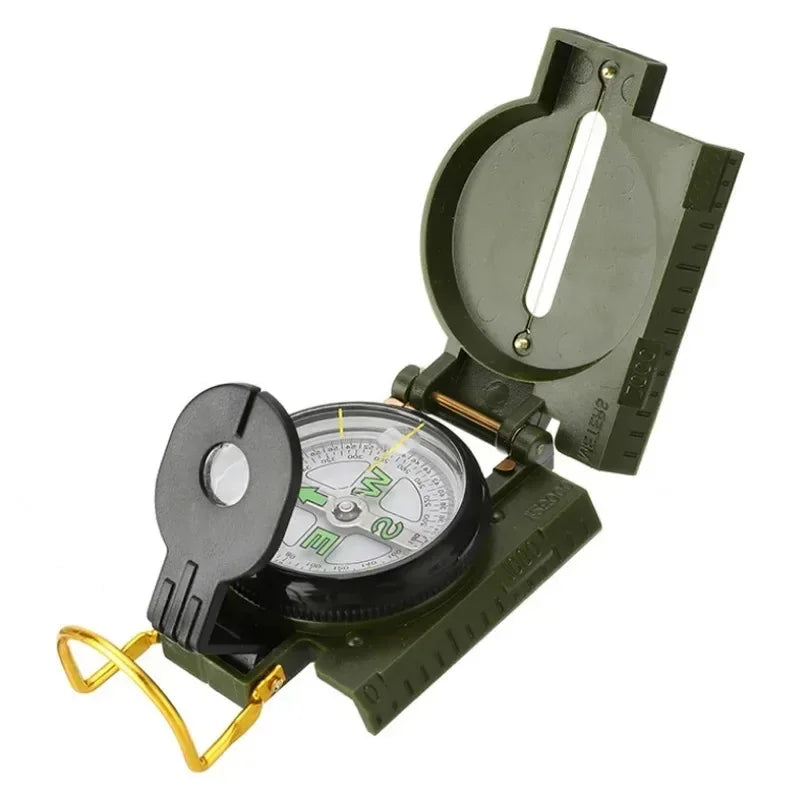 An olive green military-style compass with a black cover flap, gold-colored metal loop, and a white measurement scale on the open cover, shown on a white background.