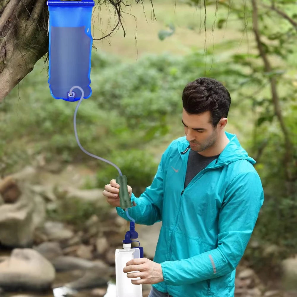 Man using a portable water filter system outdoors
