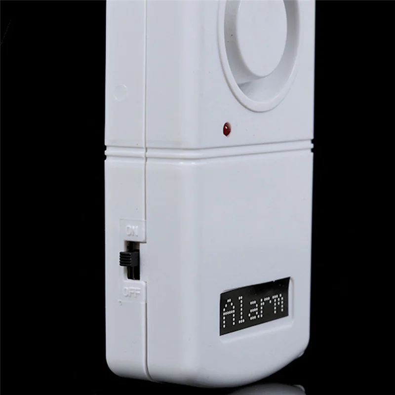 White alarm device with a visible brand name on a black background