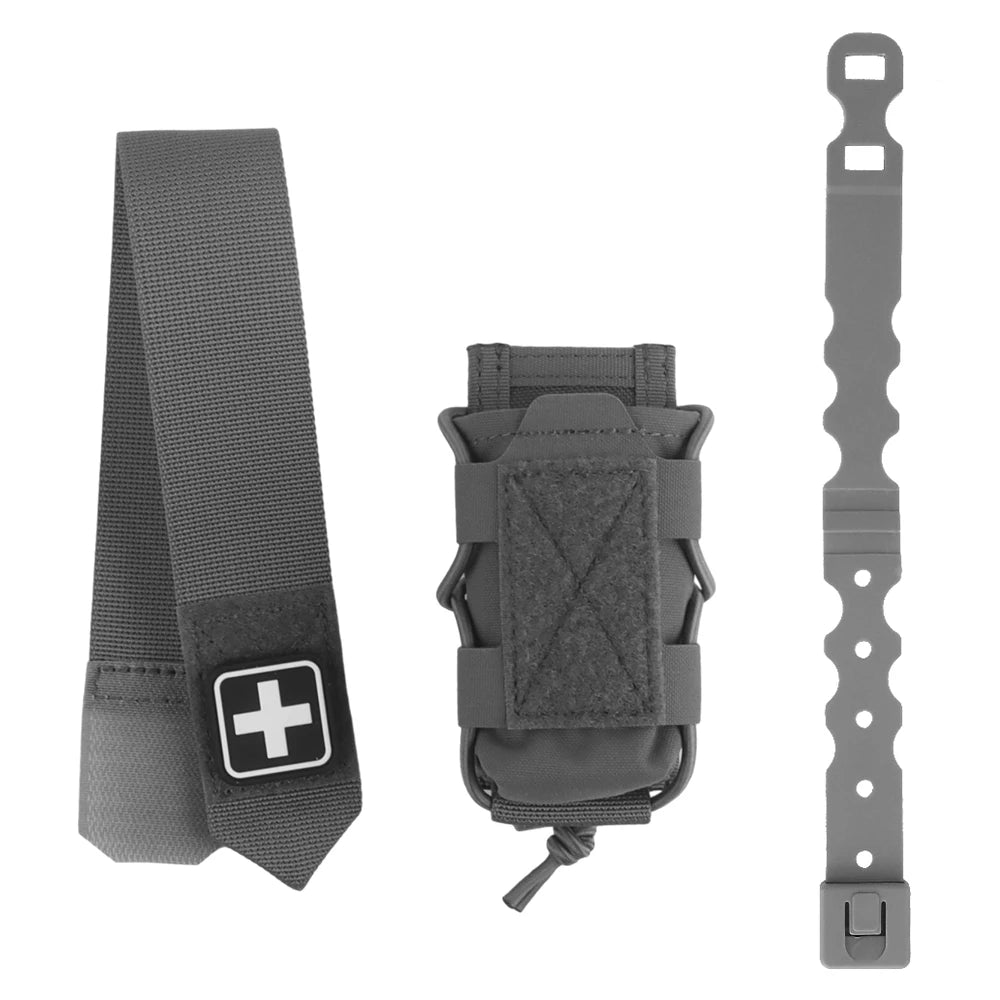 A dark gray tactical medical kit accessory set on a white background, including a wide strap with a white cross patch, a small utility pouch, and a long mounting clip.