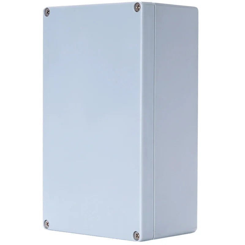 A light blue-gray metal junction box with four corner screws, shown from a three-quarter angle against a plain white background.