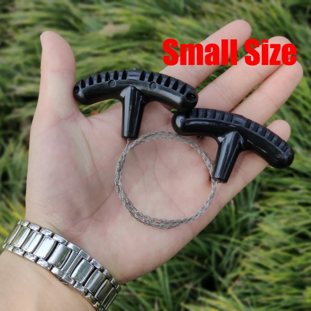 A hand holding two small black plastic loop-like accessories with a thin gray wire loop, set against a blurred green grass background. Red text at the top reads 'Small Size'.