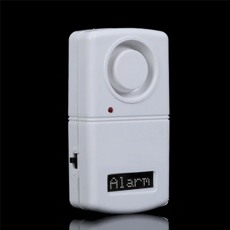 White alarm device with a digital display on a black background