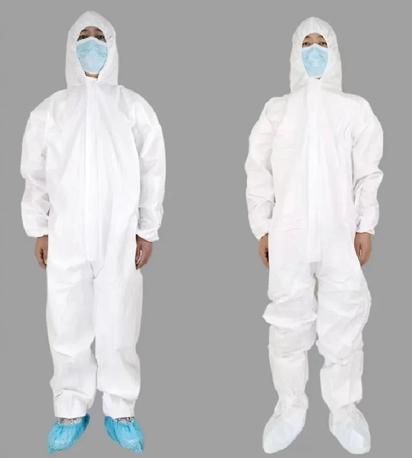 Two people wearing white protective suits and blue medical masks on a gray background