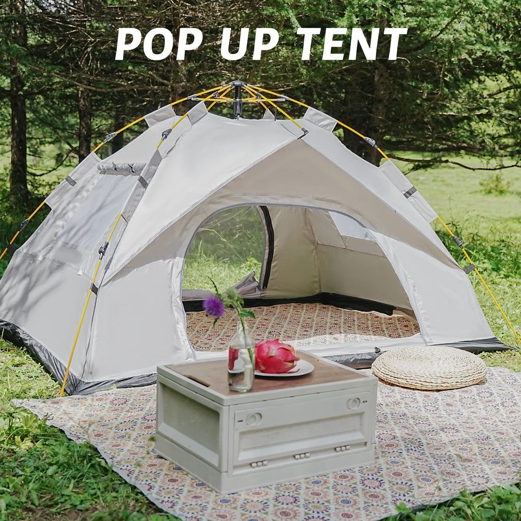 Pop-up tent set up outdoors with a table and decorative items.