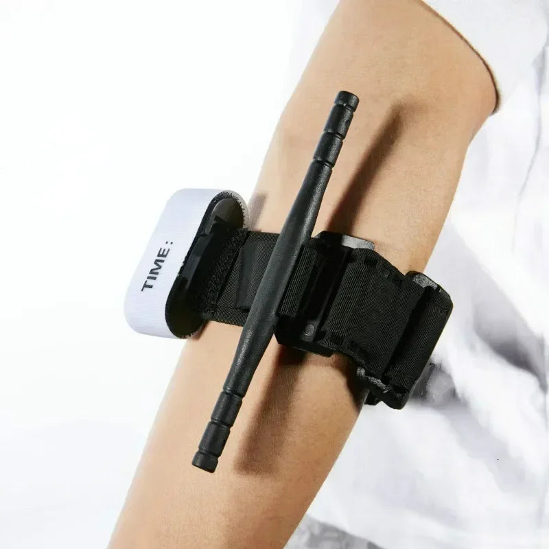 Black arm band with a pen holder attached to a person's arm, with a white background.
