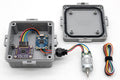An electronic sensor kit with a gray waterproof junction box shown both open and closed, a small blue circuit board module, a purple signal conditioning board, a small motor, and a coiled multicolor wire harness on a white background.