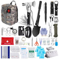 A comprehensive outdoor survival and first aid kit set arranged on a white background. The set includes a camouflage backpack with a red cross, a multi-tool axe, a black folding shovel, a tactical pen, a flashlight, carabiners, gloves, paracord, a first aid kit pouch, alcohol pads, bandages, and other survival supplies.