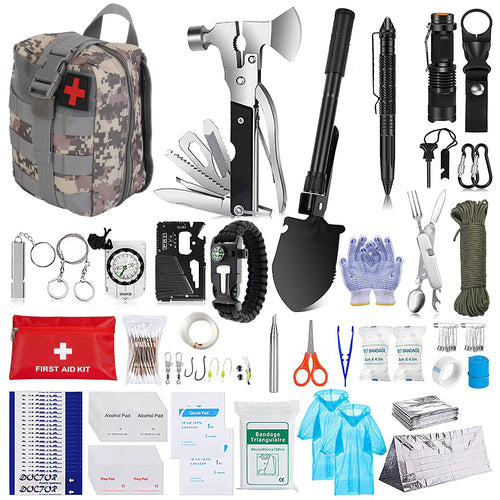 A comprehensive outdoor survival and first aid kit set arranged on a white background. The set includes a camouflage backpack with a red cross, a multi-tool axe, a black folding shovel, a tactical pen, a flashlight, carabiners, gloves, paracord, a first aid kit pouch, alcohol pads, bandages, and other survival supplies.