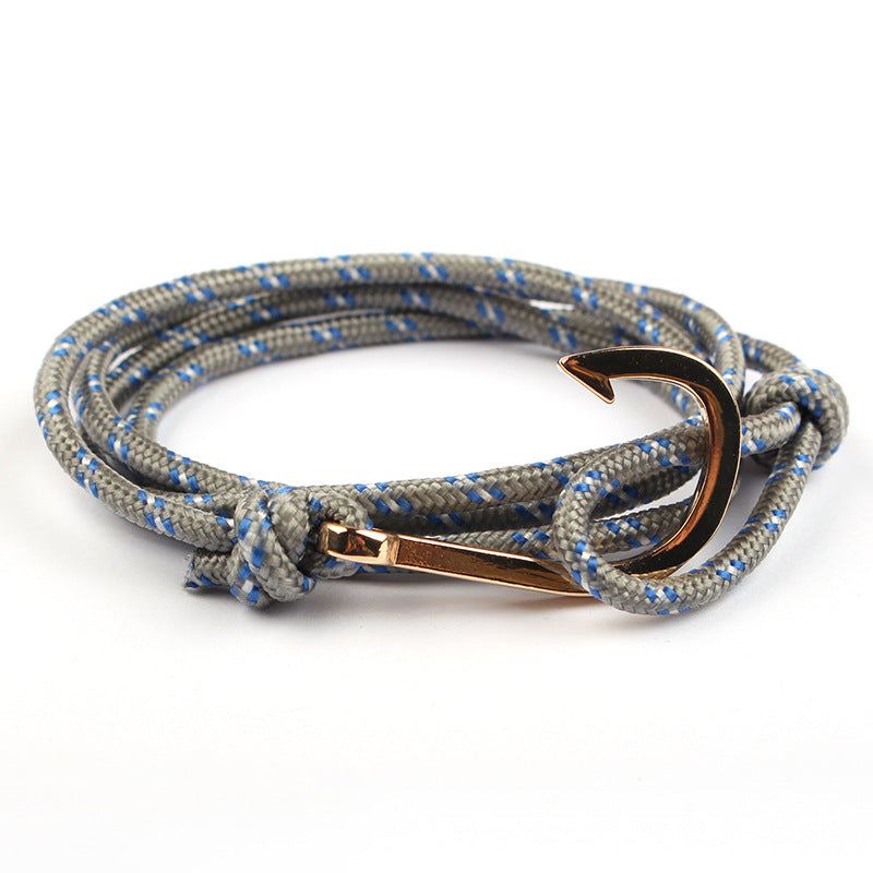 Bracelet with rope design and rose gold anchor clasp on a white background